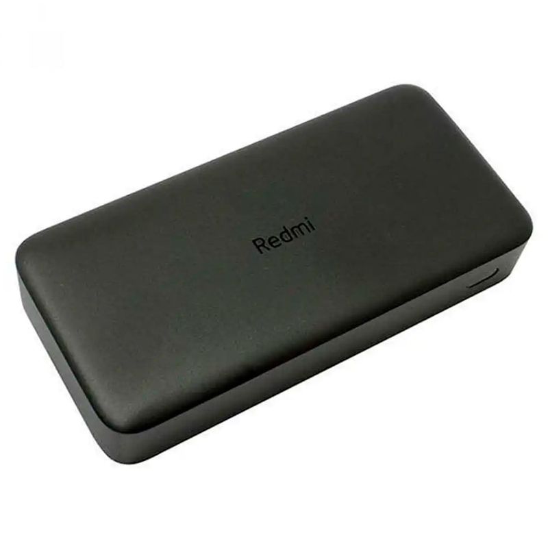 Batería externa Xiaomi Redmi 20000 mAh 18W negro vista oblicua superior recostada en superficie blanca